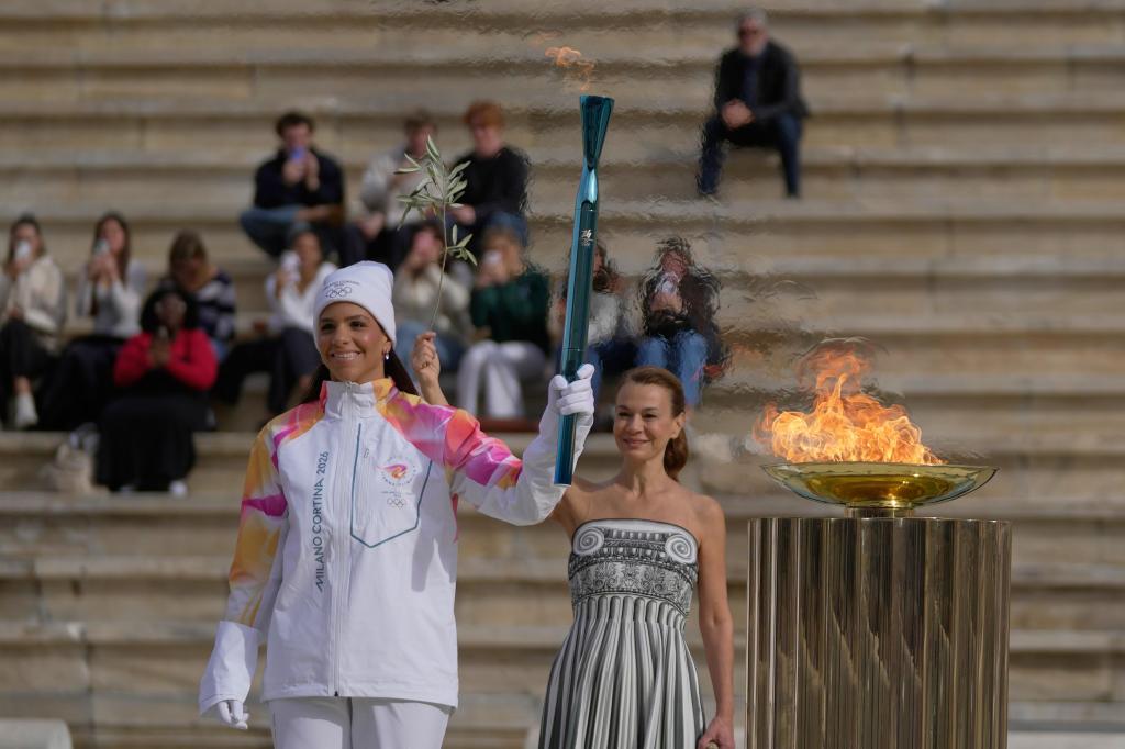 Olympic flame for Winter Games handed to Italian organizers